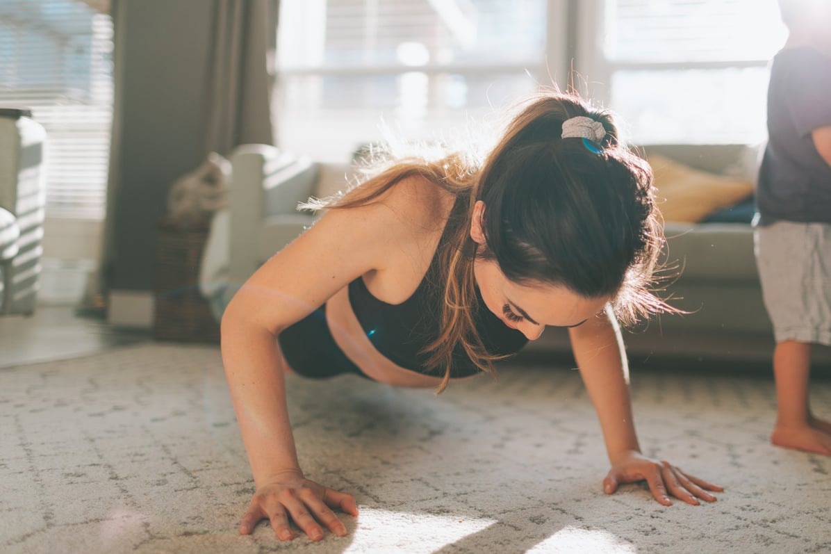 Woman Exercising at Home While Her Son Plays