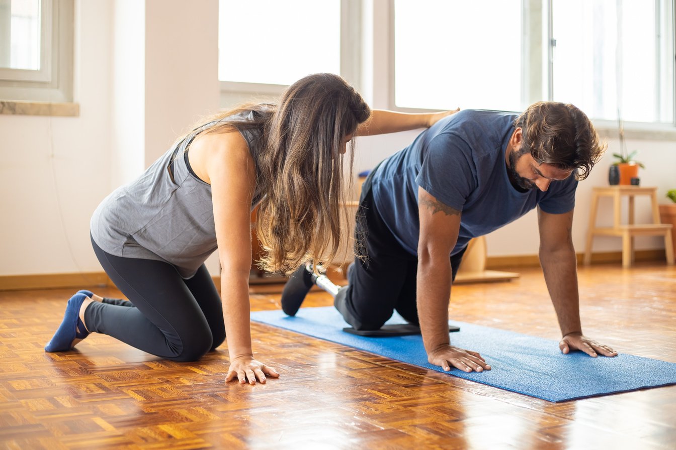 A Woman Supporting Man doing Exercise